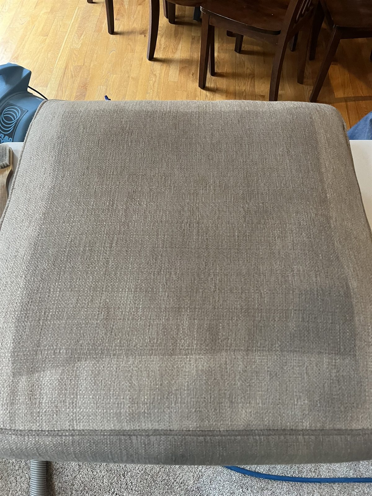 A close upholstery before-and-after cleaning comparison on a cushion