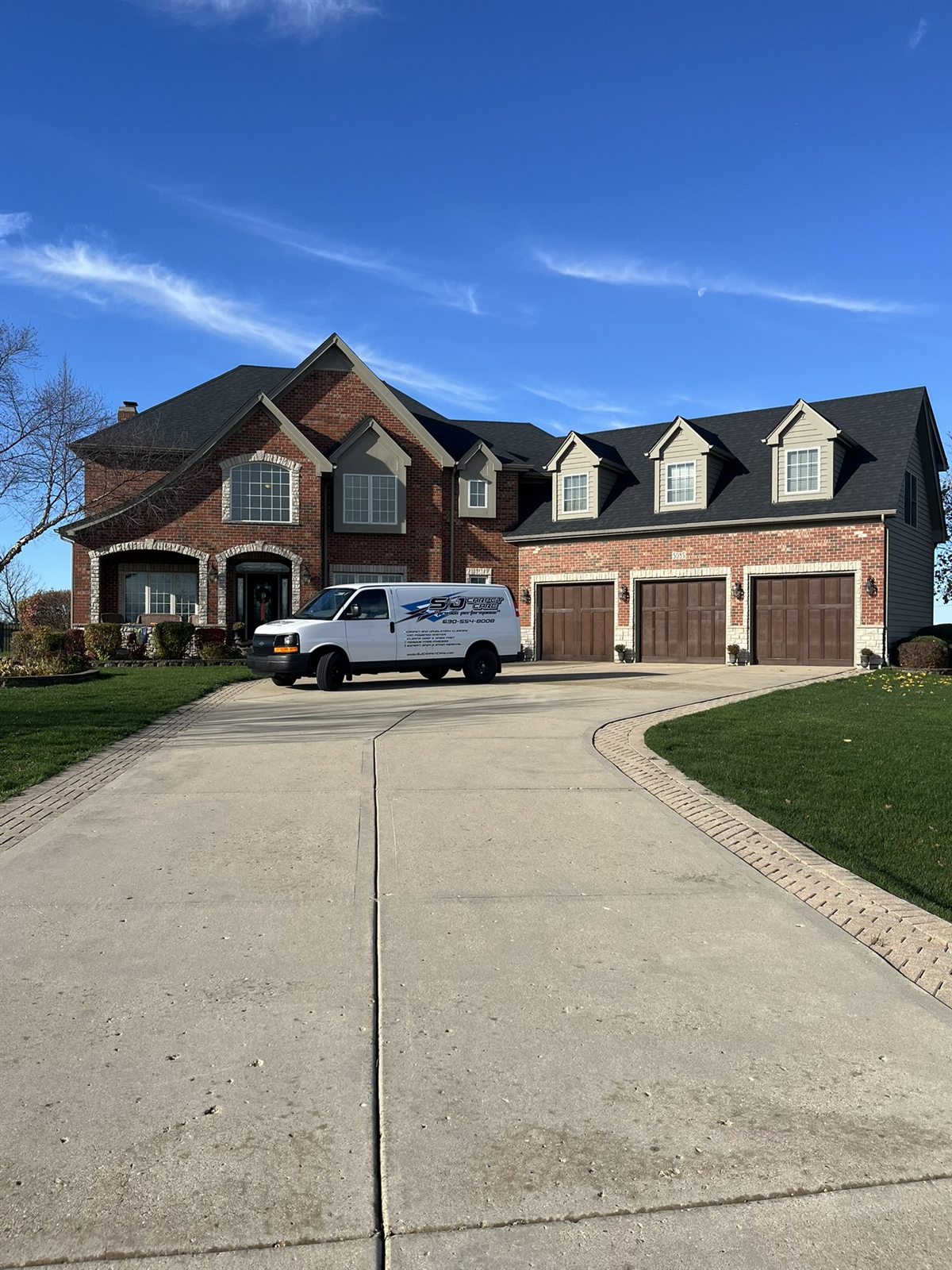 The S&J branded van parked at a customer home